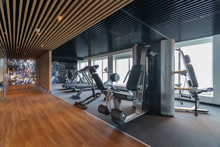 Ultramarine Fitness center with workout equipment and floor to ceiling windows