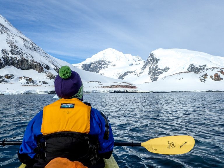 A paddler taking in the spectacular mountain views while kayaking in Antarctica.